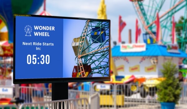 Amusement park ride name and timings shown on a digital display