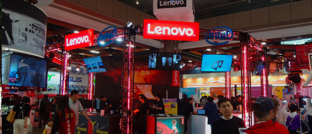 A woman looking at a digital signage kiosk at a trade show.