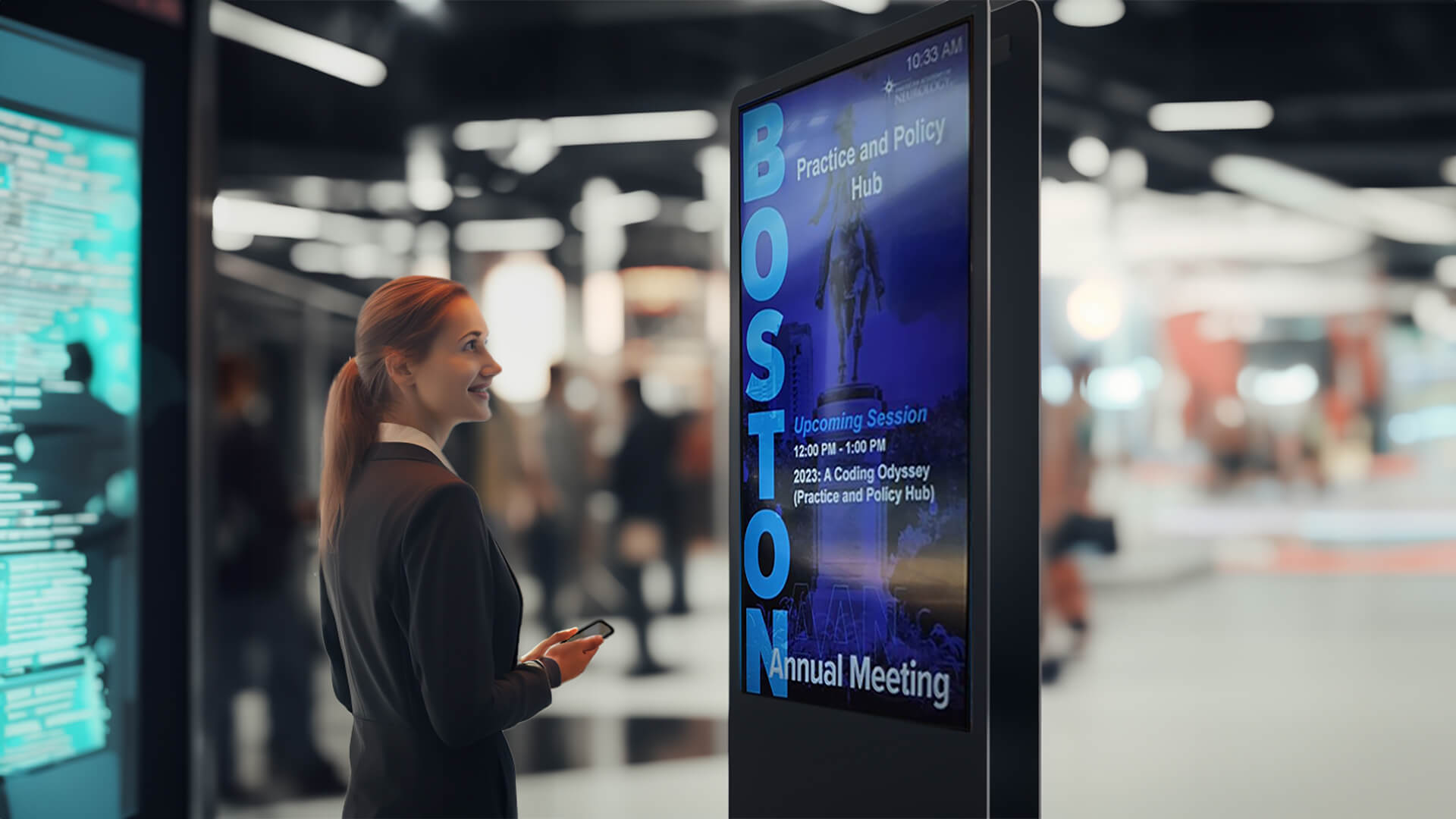 A woman looking at a digital signage kiosk at a trade show.