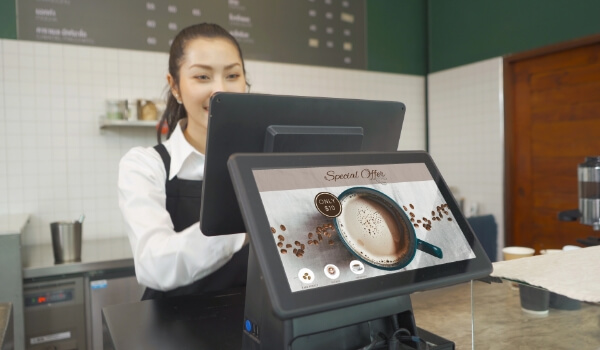 Digital tablet at a restaurant Point of Sale (PoS) promotes a special offer to attract customers