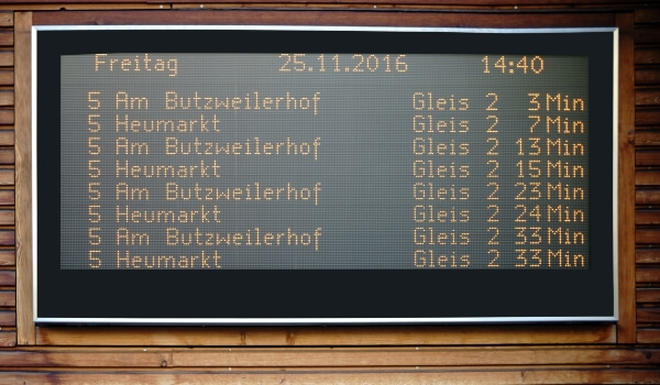 An electronic message board shows train schedules and ETAs