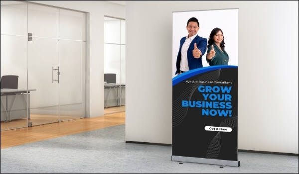 A freestanding banner inside a marketing agency shows promotional messages at the office lobby