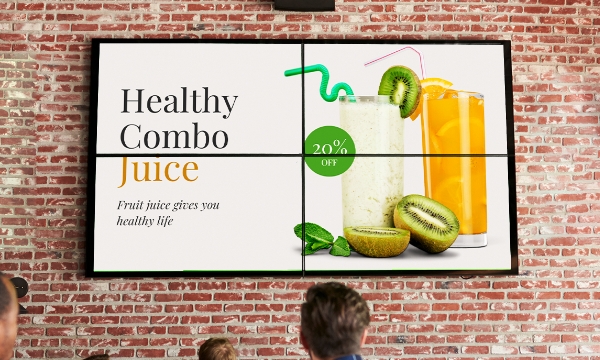 A video wall made of 4 digital screens displays juice-combo offer at a restaurant