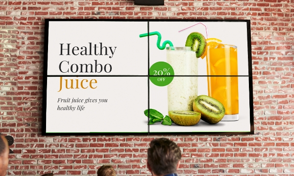 A video wall made of 4 digital screens displays juice-combo offer at a restaurant