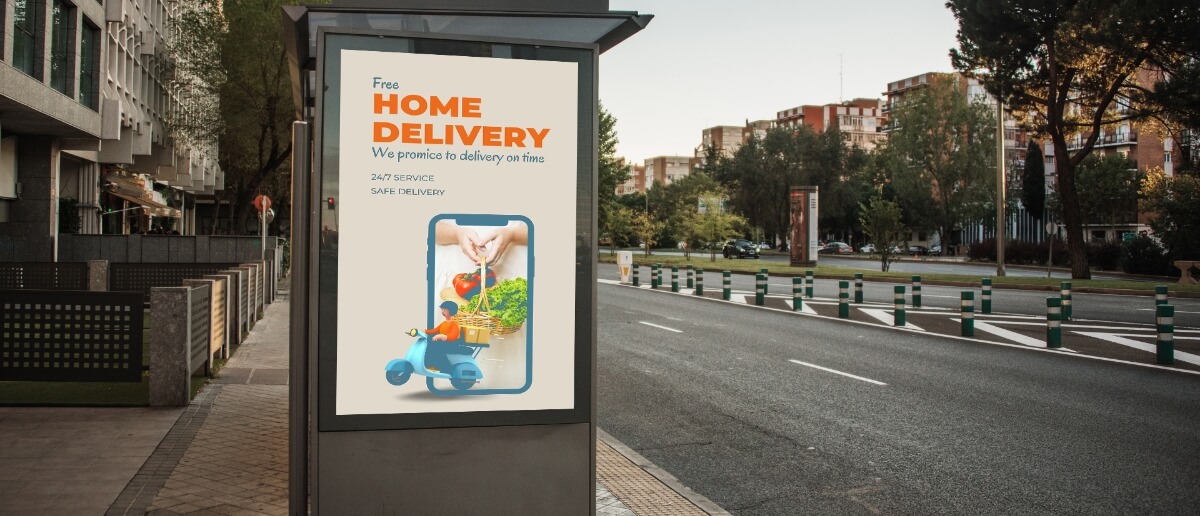 A digital out of home (DOOH) signage shows the advertisement of free home delivery of groceries by a brand