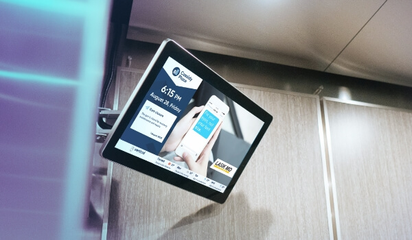 An elevator DOOH shows Lasik MD's programmatic ads