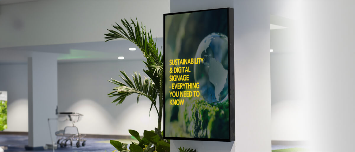  Digital signage displaying eco-friendly messages and green energy symbols, promoting sustainability in using digital signage